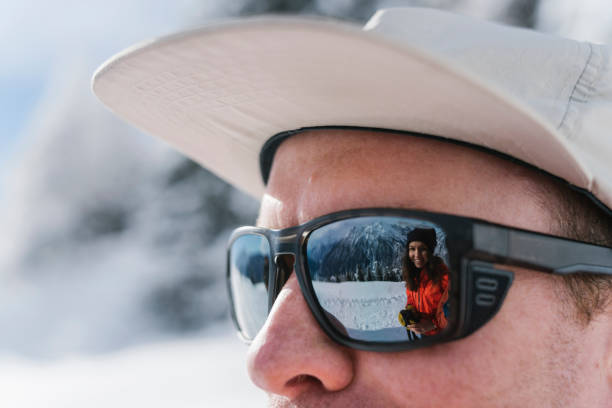 Friend smiling is reflected in his sunglasses